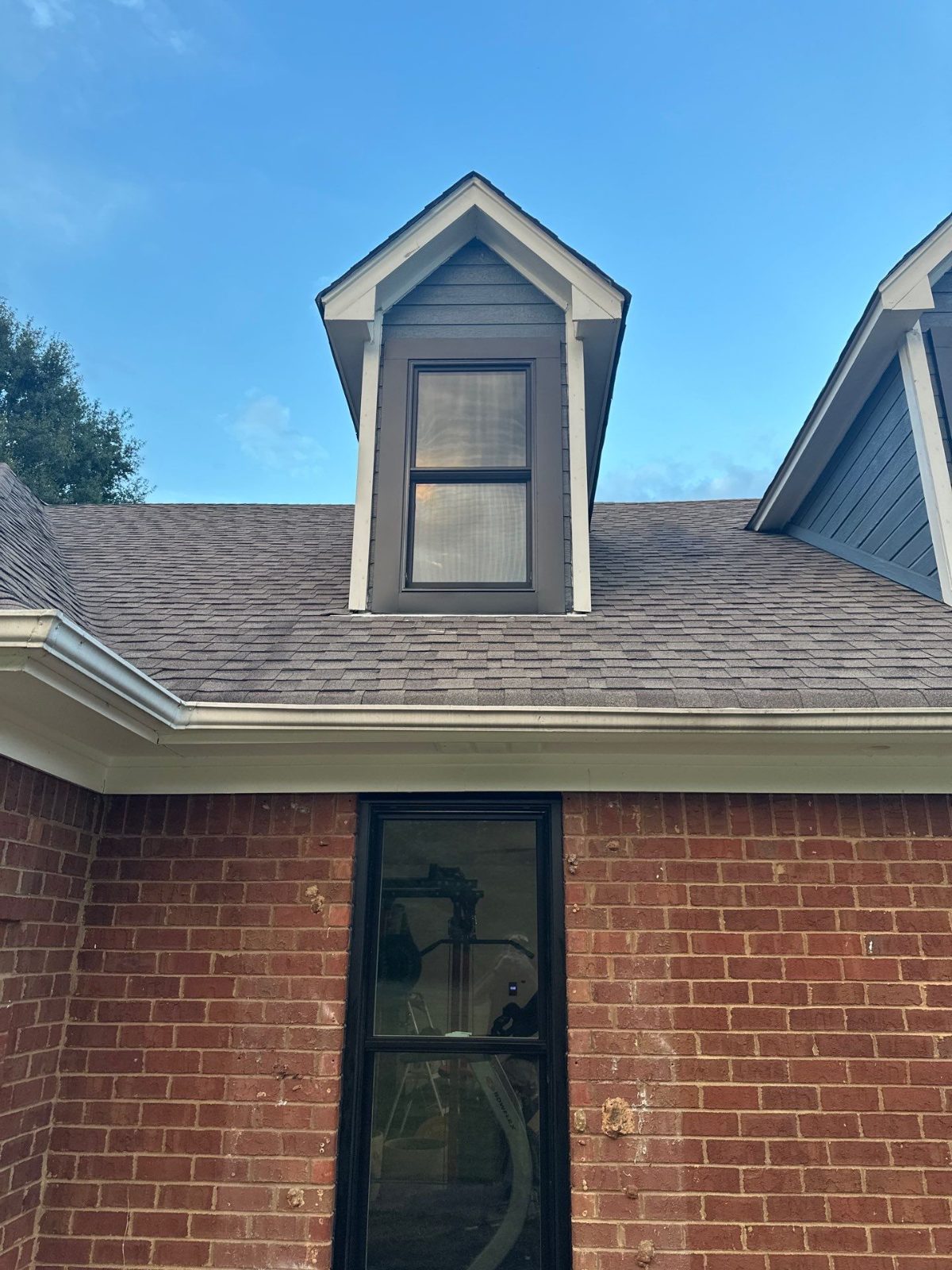 New shingle roof around a dormer on a Hernando MS home