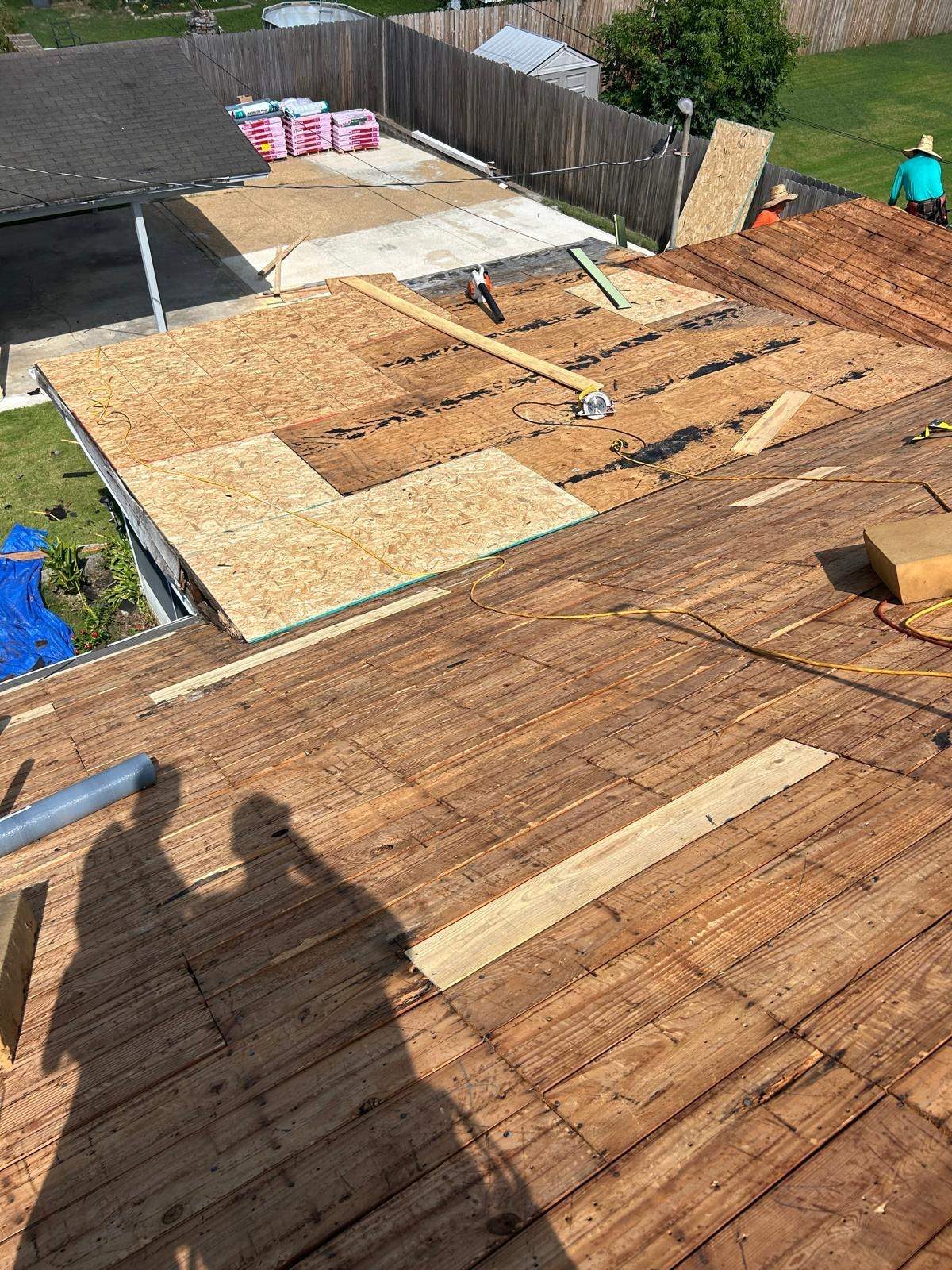 Old plank roof deck with new sheathing patches on a Memphis TN home