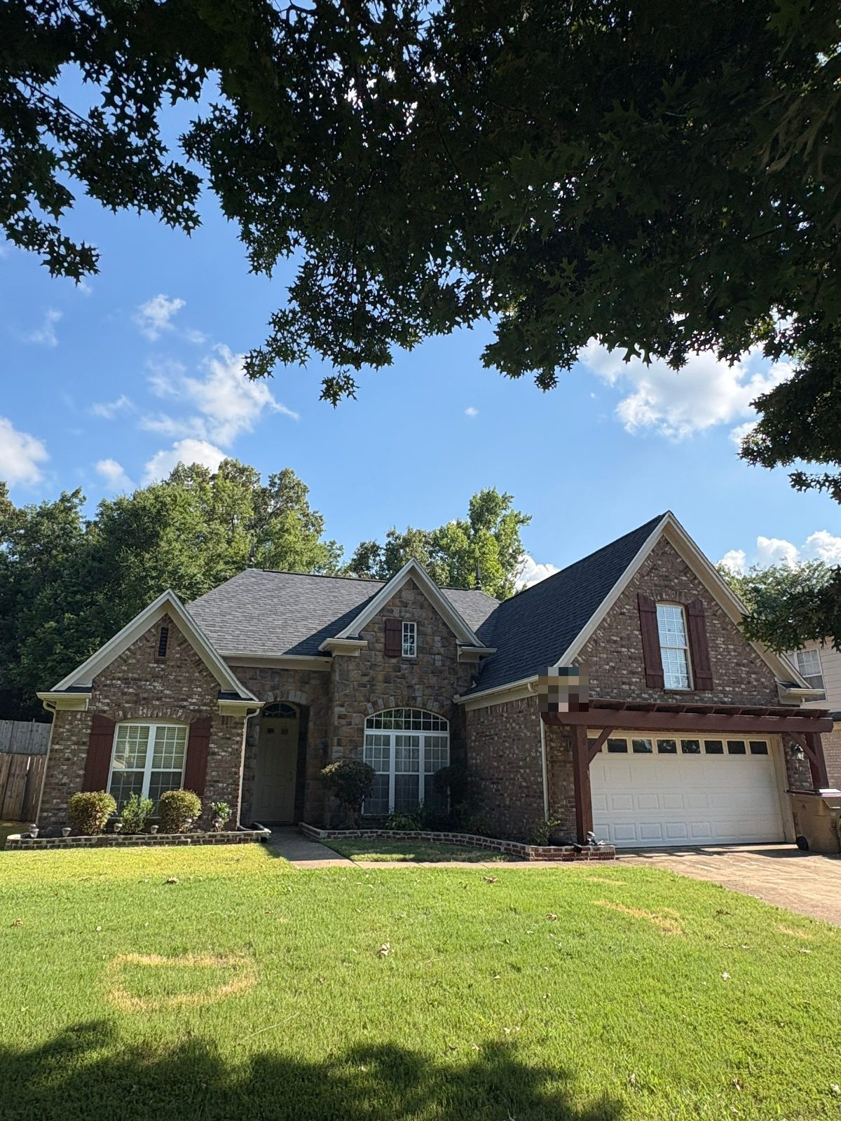 Completed roof replacement on a brick and stone home in Cordova TN