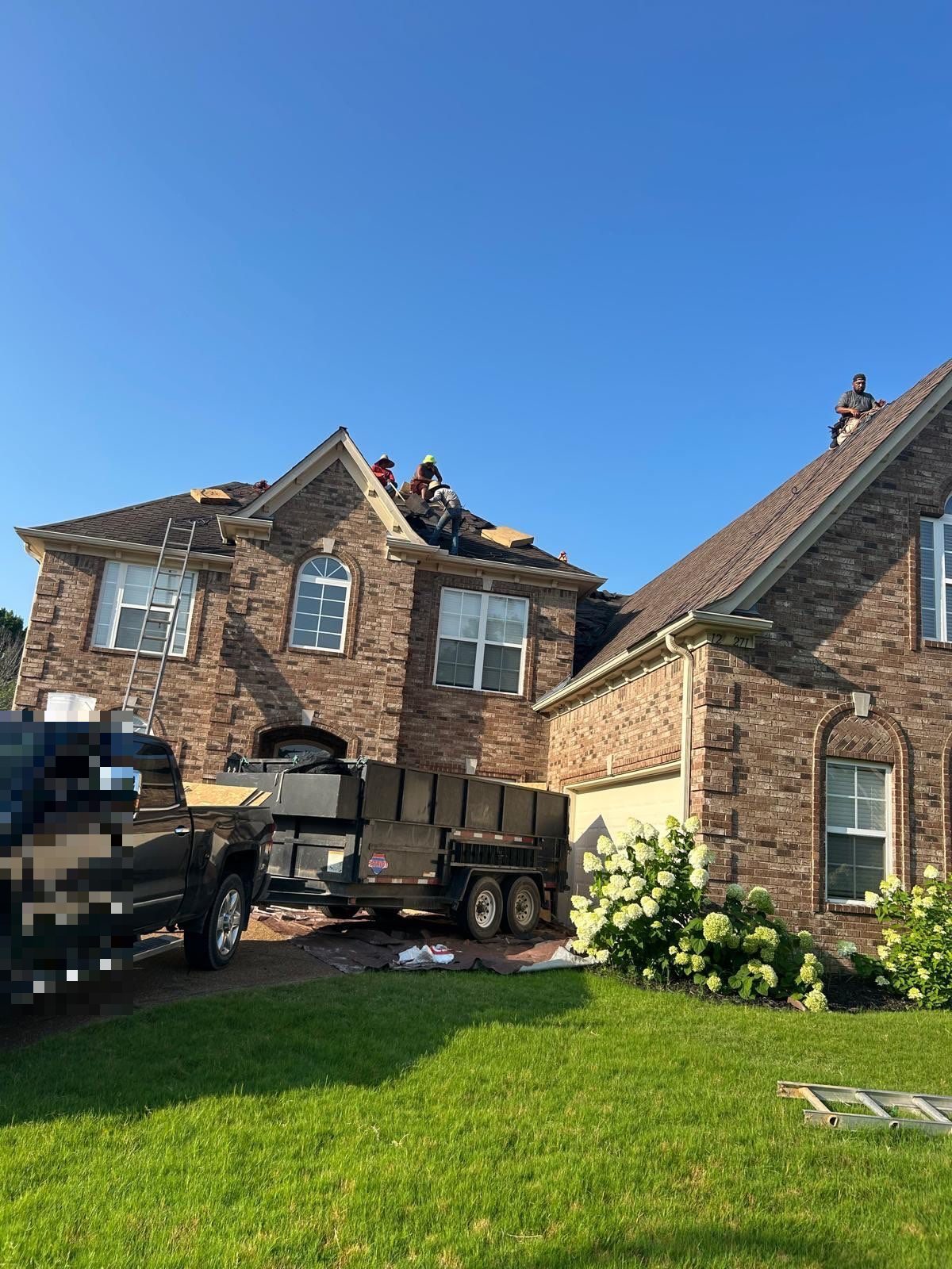 Metro Builders crew and trailer at a roof replacement in Arlington TN