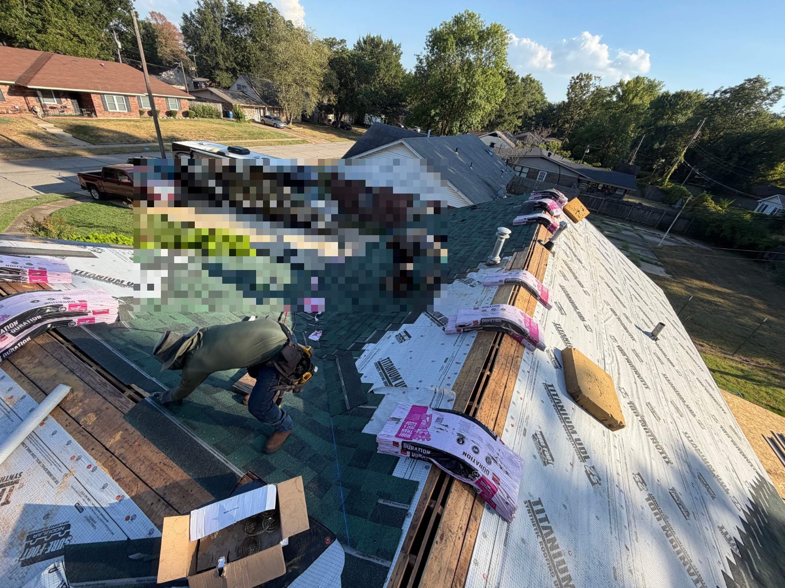 Crew installing synthetic underlayment in West Memphis AR