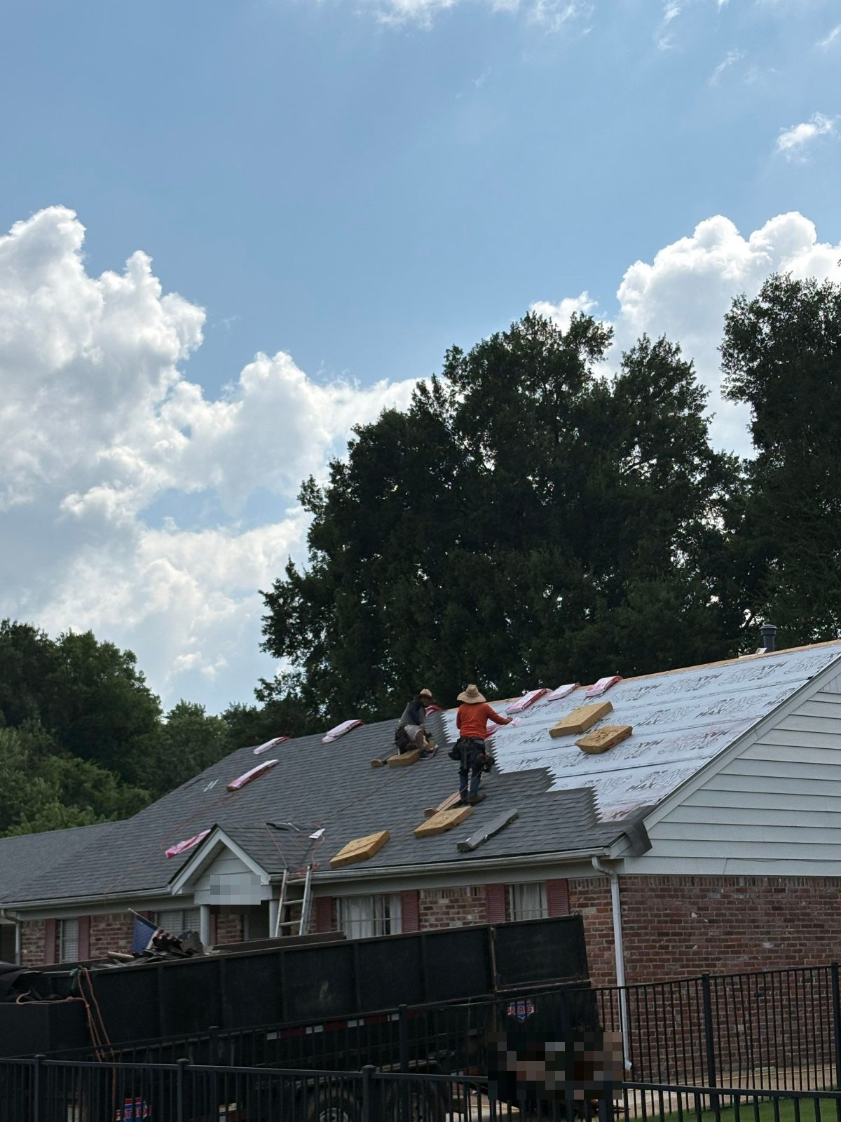 Roofers installing new shingles on a Memphis TN home
