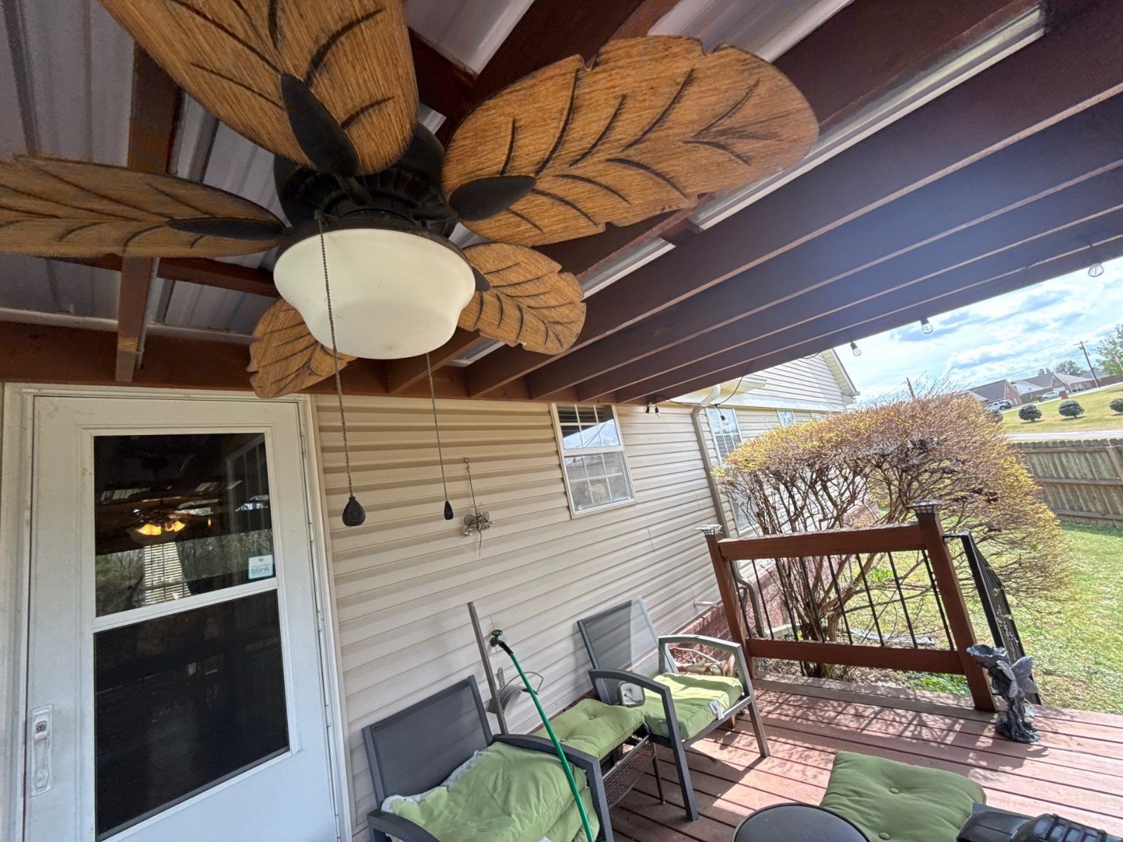 Finished covered patio with a metal roof and ceiling fan in Millington TN