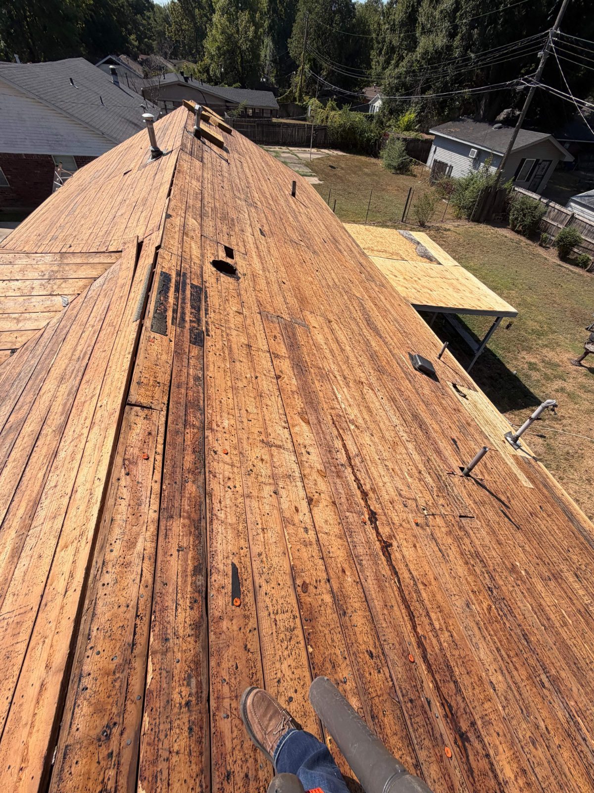 Original plank roof decking exposed at tear-off in West Memphis AR